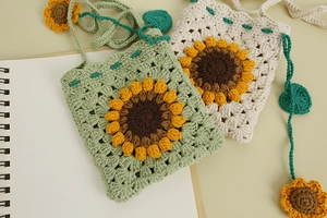 Detail of handmade crochet sunflower crossbody bags in green and beige cotton yarn