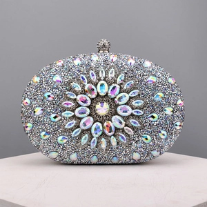 Close-up of sparkling silver evening bag with colorful rhinestones and crystal clasp