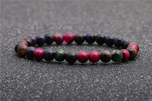 Macro shot of colorful tiger eye stone beaded bracelet with glossy chatoyancy finish