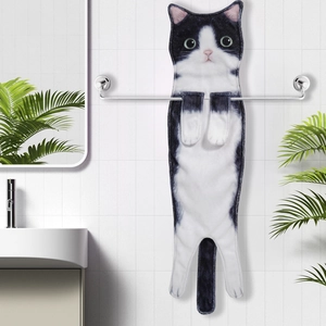 Hanging creative black and white cat shaped hand towel in clean bathroom setting