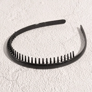 Detail of black wave headband showing anti-slip teeth and smooth glossy finish