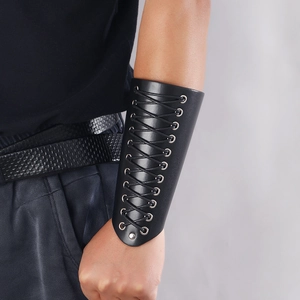 Close-up of punk black leather arm guard with adjustable lace-up ties on model arm