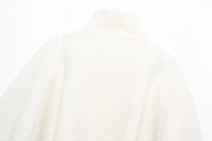 Close-up of elegant white mixed-blend wool texture on back shoulder and collar