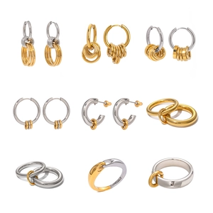 Collection of minimalist two-tone stainless steel hoop earrings and intertwined rings