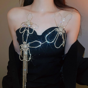 Exquisite close-up of a silver body chain with diamond-encrusted flower and tassel details