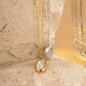 Gold and silver oval mother of pearl pendant necklaces on natural stone with ball chain