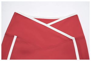 Detailed view of high-waisted crossover waistband and red contrast trim on gym shorts