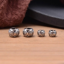 Macro shot of S925 sterling silver retro spacer beads with traditional longevity pattern