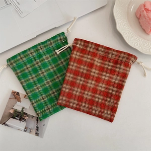 Detail of red and green plaid drawstring pouches for jewelry and small accessories