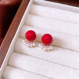 18k gold plated stud earrings featuring a red round bead and pearl fan pendant