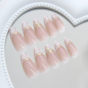 French almond press-on nails with white marble tips and gold metallic line details