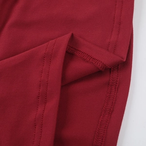 Detailed close-up showing the double-needle stitching on the dark red mesh dress hem
