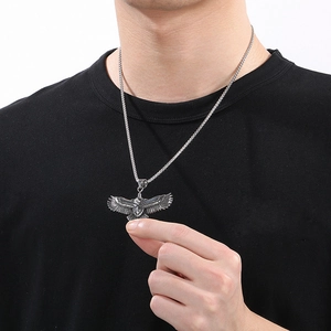 Men's retro stainless steel eagle pendant necklace worn on a black t-shirt model