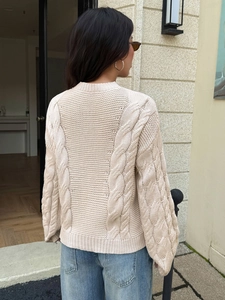 Women's beige chunky cable knit sweater with puff sleeves and casual loose fit back view