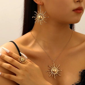 Detailed view of bohemian gold sun jewelry set including necklace, earrings and ring