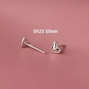 Macro shot of S925 sterling silver heart stud earrings with beaded edges and hallmark