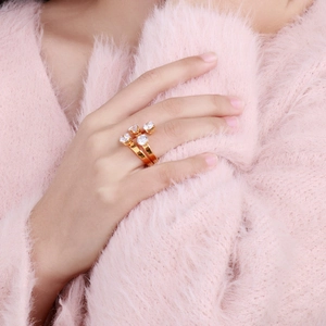 Detailed close-up of 18K gold stainless steel open ring with four bright diamonds