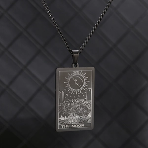 Macro shot of black stainless steel Tarot pendant showing The Moon design details