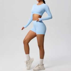 Close-up of light blue seamless yoga set with long sleeve crop top and high waist shorts