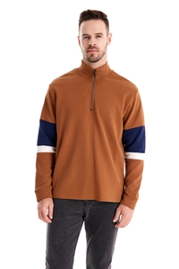 Detail of men's brown sweatshirt featuring half-zip collar and navy white striped sleeves