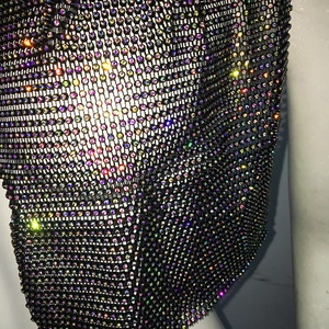 Close-up of sparkling rainbow rhinestones on black mesh fabric for party headwear