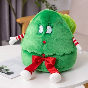 Close-up of green Christmas tree plush toy with striped legs and red bow tie