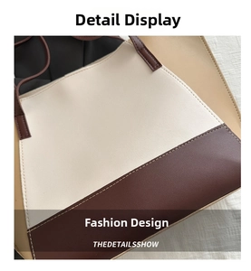 Close-up of three-tone stitching and leather texture on a large capacity tote bag