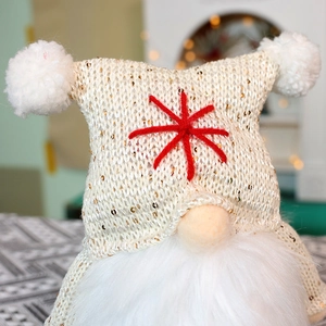 Close-up of a Christmas gnome with a sequined knit hat and soft white faux fur beard