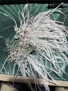 Detail of white bridal feather headband with silver leaf wire, crystals and opals