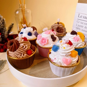 Set of six creative cupcake scented soy candles with realistic cream and fruit toppings