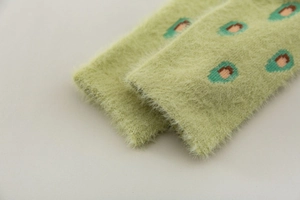 Close-up of green mink velvet socks showing soft texture and blue pattern details