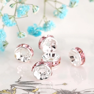 Macro shot of pink rhinestone spacer bead for DIY jewelry making with silver metal base