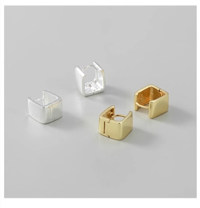 Detailed close-up of S925 sterling silver stamp on polished square hoop earrings