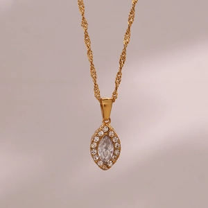 Macro shot of marquise gold pendant with clear zircons on water wave chain