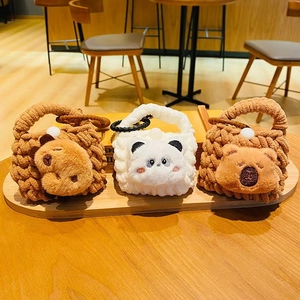 Three knitted cartoon animal earphone pouches including bear, panda and koala bag charms