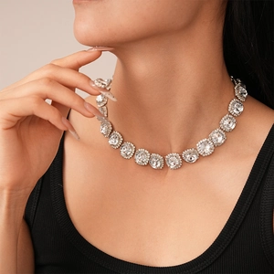 Close-up of elegant silver necklace set with round rhinestones on model for banquet
