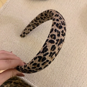 Close-up of leopard print thick fabric headband showing soft texture and pattern