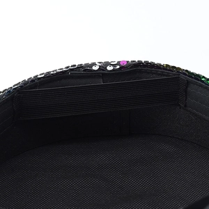 Detail view of the black rhinestone captain hat showing the elastic band and sequins