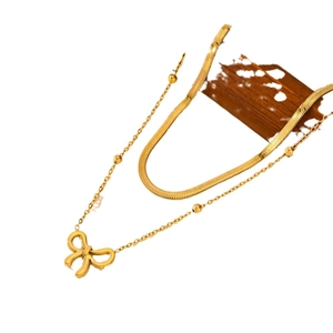 Exquisite gold layered bow necklace featuring a bead chain and sleek snake chain design