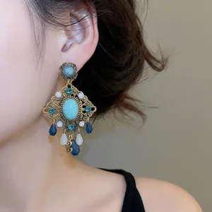 Vintage bohemian drop earrings featuring turquoise stones and intricate gold metalwork