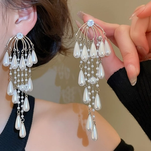 Elegant silver tassel earrings featuring drop pearls and sparkling zircon accents
