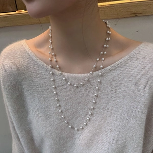 Elegant double-layered faux pearl necklace with silver chain on model, french style