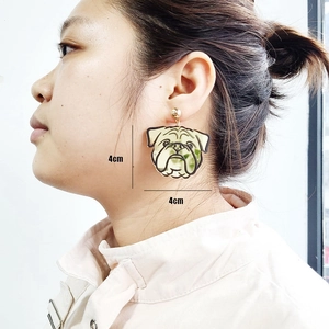 Detail shot of light green and beige French Bulldog puppy acrylic earrings, size 4cm x 4cm