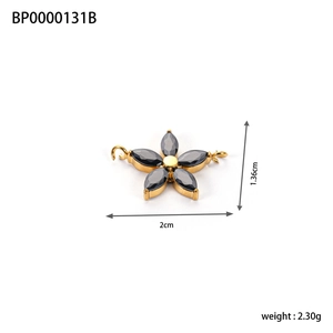 Macro view of gold flower pendant with black zircon inlays and dimensions text