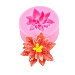 Detailed silicone mold and finished red poinsettia flower with yellow stamens for DIY crafts