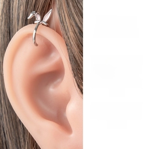 Detailed view of silver rabbit ear cuff with pink enamel on a silicone ear model