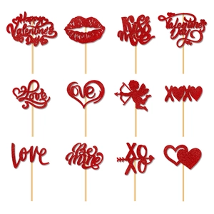 Close-up of 12 red glitter Valentine's Day cupcake toppers with Love and Heart patterns