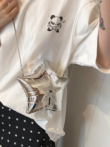 Detail of silver star-shaped bag featuring sparkling rhinestones and elegant metal fringes