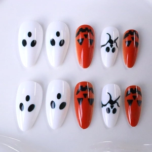 Long almond press-on nails with Halloween orange pumpkin and white ghost designs