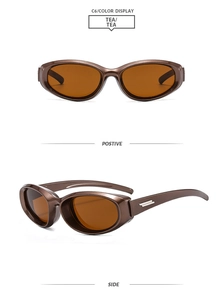 Detail view of tea-colored oval sunglasses with polished resin frame and metallic side accents